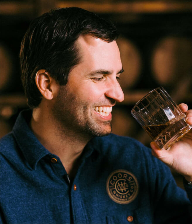 man drinking whiskey from glass