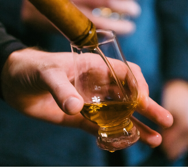 pouring whiskey on glass