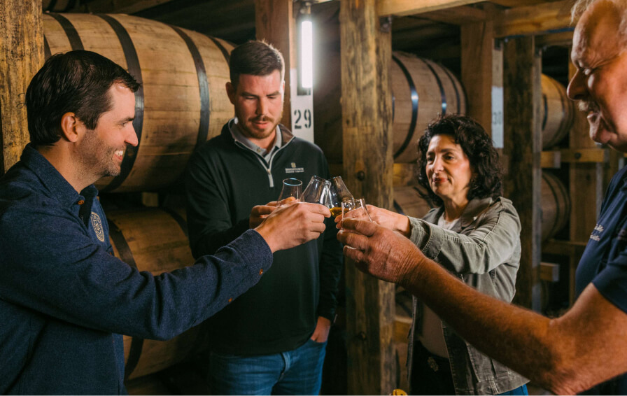 group of people drinking whiskey